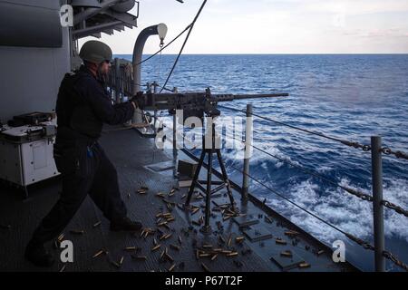 160514-N-EH218-005  SOUTH CHINA SEA (May 14, 2016) –  Fire Controlman 1st Class Christopher Guilford, from Panama City, Fla., fires an M-2 .50-caliber machine gun during a live fire exercise aboard the guided-missile cruiser USS Mobile Bay (CG 53).  Providing a ready force supporting security and stability in the Indo-Asia-Pacific, Mobile Bay is operating as part of the John C. Stennis Strike Group and Great Green Fleet on a regularly scheduled 7th Fleet deployment. (U.S. Navy photo by Mass Communication Specialist 2nd Class Ryan J. Batchelder/Released) Stock Photo