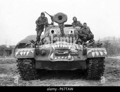 Photograph of soldiers sitting on a painted M-46 tank, the tank is painted to look like a fierce tiger. Taken during the Korean War, a war between the Republic of Korea (South Korea) and the Democratic People's Republic of Korea (North Korea), in which a United Nations force dominated by the United States of America intervened to support the South and China intervened to support the North. Dated 1951 Stock Photo