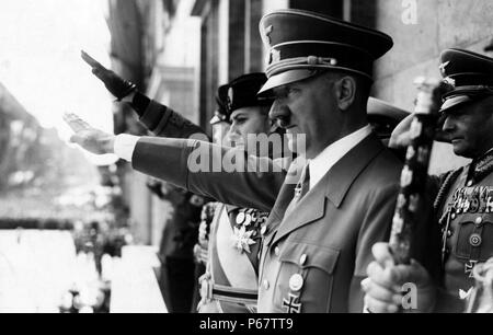 Adolf Hitler and Count Ciano salute on a chancellory balcony in Berlin. Hitler was chancellor of Germany from 1933 to 1945 and dictator of Nazi Germany from 1934 to 1945. Hitler was at the centre of Nazi Germany, World War II in Europe, and the Holocaust. Stock Photo