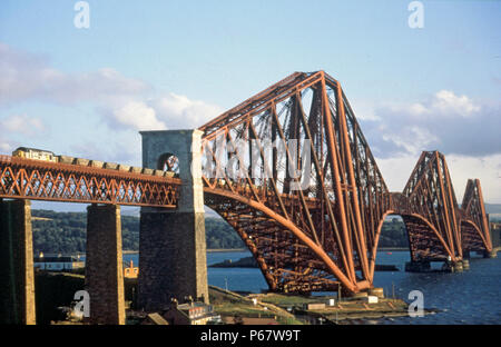 The Forth Bridge over the Firth of Forth with a coal train crossing hauled by a Class 37 diesel electric. C 1993 Stock Photo