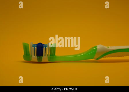 Things, personal hygiene products, new toothbrush placed on yellow background. Stock Photo