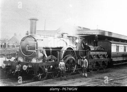 The last up (London Bound) GWR Broad Gauge mail train from Plymouth hauled by Rover Class 4-2-2 Bulkeley taking water at Didcot. 20th May 1892 Stock Photo