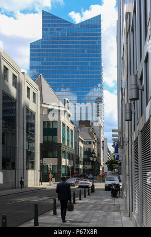 Man walking down the street in the Northern Quarter of Brussels with the Rogier Tower in the background, Brussels, Belgium. Stock Photo