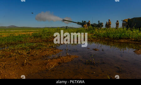 Students at the Field Artillery Basic Officers Leadership Course fire from a M777A2 Howitzer at Fort Sill, Oklahoma, May 11, 2016. The course allows officers to get a general understanding of what the Marines they lead will be doing in a deployed environment. Stock Photo