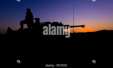 A student at the Field Artillery Basic Officers Leadership Course awaits a call for fire at Fort Sill, Oklahoma, May 12, 2016. Officers at the course are taught how to properly execute fire missions. Stock Photo