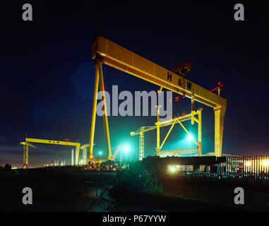 Gantry cranes in the Harland and Wolff shipyard, constructed by the German engineering firm Krupp, with Goliath being completed in 1969 and Samson in  Stock Photo