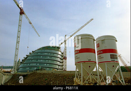 On site concrete batching plant. Cement Silo on a building site. In the background, City Hall, Greater London Authority, GLA Building by Tower Bridge, Stock Photo