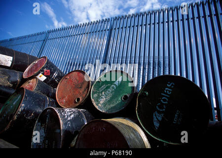 Stockpile of used steel drums in compound. Stock Photo