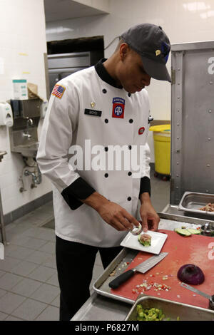 Spc. Onaje Boyd, a culinary arts specialist with the 3rd Brigade Combat Team, 82nd Airborne Division and Fort Lauderdale, Fl. native, completes a tuna tartar with mango and passion fruit chutney during the All American Week 2016 Culinary Competition at the Culinary Arts Training Center on Fort Bragg, N.C., May 23. All American Week is an opportunity for 82nd Abn. Div. Paratroopers, past and present, and their Families to come together and enjoy the camaraderie and celebrate being members of the All American Division. This year's All American Week theme is 'Tomorrow's Force, Today!' (Photo by S Stock Photo