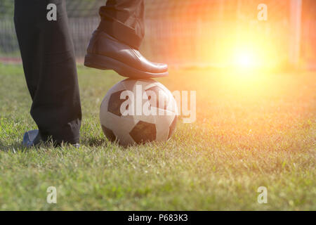 Businessman playing with soccer ball, Asian businessman with football in the stadium foolball, Soccer ball Stock Photo