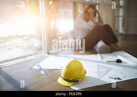 Stressed businessman with head in hands at office, Business failure concept, Blurred background Stock Photo