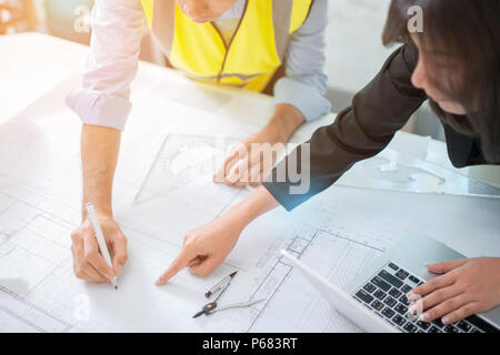 Hands of architects working on blueprints in the office, selective focus Stock Photo