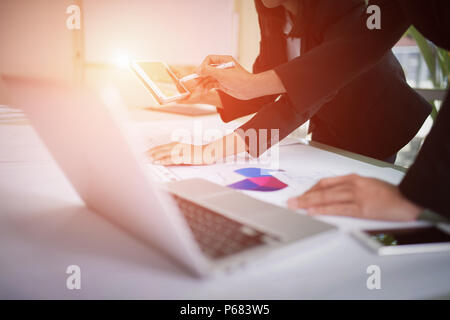 Team of business discussion of project, closeup hand of business man holding pen and pointing to tablet Stock Photo