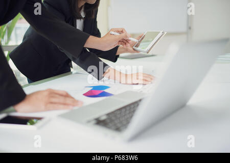 Team of business discussion of project, closeup hand of business man holding pen and pointing to tablet Stock Photo