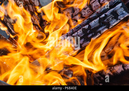 crest of flame on burning wood in fireplace. Stock Photo