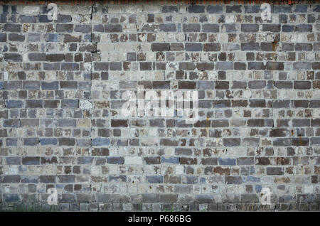 The texture of the warehouse wall from a variety of rough stones of different shades . Stock Photo