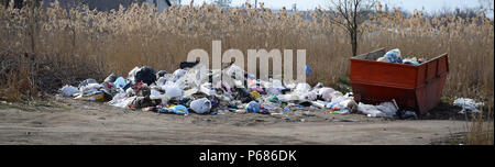 The garbage can is packed with garbage and waste. Untimely removal of garbage in populated areas . Stock Photo