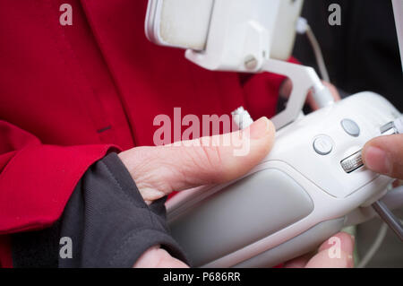 Pilot maneuver dron on remote controller. Gimbal tilt wheel Stock Photo