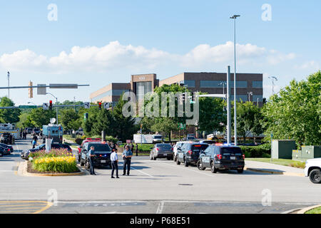 Annapolis, Maryland, USA. 28th June, 2018. June 28, 2018, Annapolis Maryland - Police and Fire officials work the scene of an active shooter incident in front 888 Bestgate Road. This building is home to the Capital Gazette newspaper, a Baltimore Sun affiliate. Credit: Michael Jordan/ZUMA Wire/Alamy Live News Stock Photo