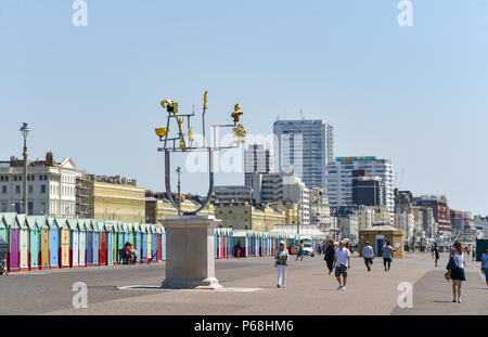 Hove Brighton UK 29th June 2018 - Walkers pass by the Hove plinth art installation called Constellation by Jonathan Wright as they enjoy the beautiful hot sunshine on Hove beach and seafront as the heatwave continues throughout Britain Credit: Simon Dack/Alamy Live News Stock Photo