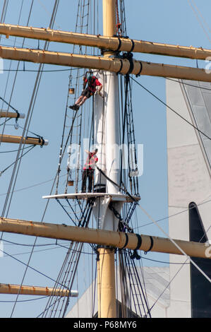 Glasgow, Scotland, UK. 29th June, 2018. Two men wearing safety harnesses carry out routine maintenance on the Tall Ship Glenlee, a restored Victorian sailing vessel permanently berthed adjacent to the Riverside Museum. Credit: Skully/Alamy Live News