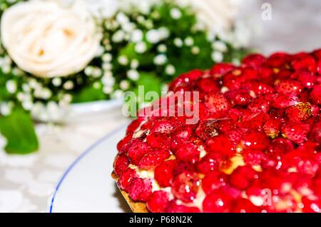 strawberry cake with flowers in the background Stock Photo