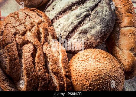 Freshly baked black and white different types of bread - food background Stock Photo