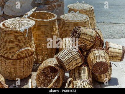 A collection of hand made wicker baskets by the side of the road for sale. Stock Image Stock Photo