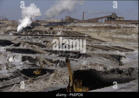 The vast opencast coal mine at Manzhouli in Inner Mongolia on the Russian border in north east China. The coal and spoil is bought out by steam trains Stock Photo