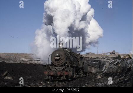 The vast opencast coal mine at Manzhouli in Inner Mongolia on the Russian border in north east China. The coal and spoil is bought out by steam trains Stock Photo