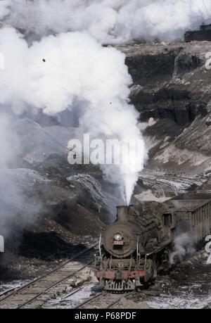 The vast opencast coal mine at Manzhouli in Inner Mongolia on the Russian border in north east China. The coal and spoil is bought out by steam trains Stock Photo