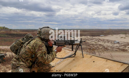 Staff Sgt. Joseph Frank, an infantryman assigned to the 2nd Battalion, 325th Airborne Infantry Regiment, 2nd Brigade Combat Team, 82nd Airborne Division qualifies with an M249 light machine gun during the Hill 187 Competition, the culminating event for Operation Viking Talon, on Garrison Petawawa, Ontario, May 17, 2016. A platoon from the 2nd Bn. 325th AIR, commanded by the 3rd Royal Canadian Regiment during Viking Talon, were invited to participate in, and subsequently won, the competition, taking the 2nd Lt. Ed Hollyer trophy. The competition takes its name from the last and bloodiest engage Stock Photo