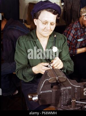 War production worker at the Vilter [Manufacturing] Company making M5 and M7 guns for the U.S. Army, Milwaukee, Wis. Ex-housewife, age 49, now doing bench work on small gun parts. World war Two; USA Stock Photo