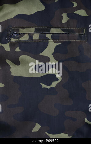 Texture of fabric with a camouflage painted in colors of the marsh with pocket. Army background image. Textile pattern of military camouflage fabric Stock Photo