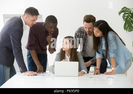 Focused diverse work team discussing online project Stock Photo