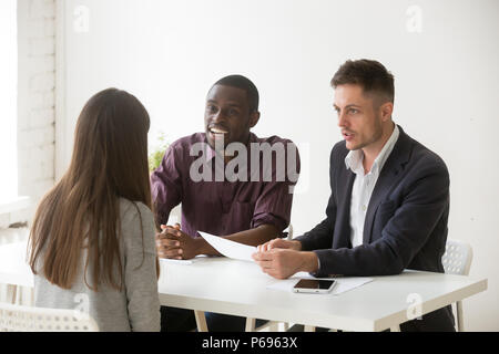 Friendly multiethnic hr team considering female candidate positi Stock Photo