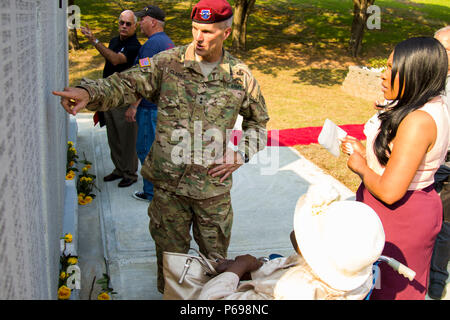 Maj. Gen. Richard Clarke, 82nd Airborne Division commanding general, finds a Gold Star Family's fallen hero on the new monument dedicated to the Paratroopers who lost their lives while conducting combat training after a memorial ceremony at the 82nd Abn. Div. War Memorial Museum on Fort Bragg, N.C., May 25.  Families, friends, and veteran Paratroopers payed their respects and honored their fallen comrades.  The new monument featured more than 220 names, all training casualties. Stock Photo