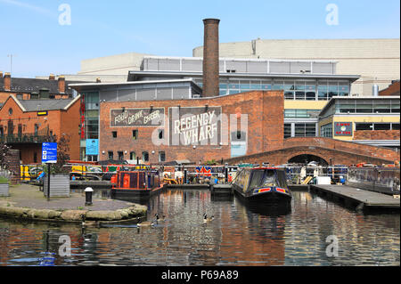 The colourful boats and barges at the back of the Regency Wharf development on the Gas Street Basin in Birmingham, in the West Midlands, in the UK Stock Photo