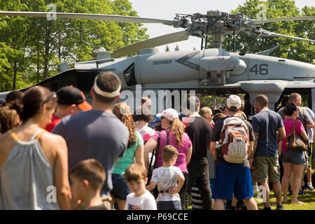 New Yorkers wait in line to tour a military aircraft during a static display as part of Fleet Week at Eisenhower Park, in East Meadow, New York, May 28, 2016. U.S. Marines and sailors are visiting to interact with the public, demonstrate capabilities and teach the people of New York about America's sea services. (U.S. Marine Corps photo by 24th MEU Combat Camera Lance Cpl. Hernan Vidana/Released) Stock Photo