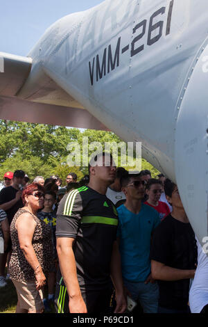 New Yorkers wait in line to tour a military aircraft during a static display as part of Fleet Week at Eisenhower Park, in East Meadow, New York, May 28, 2016. U.S. Marines and sailors are visiting to interact with the public, demonstrate capabilities and teach the people of New York about America's sea services. (U.S. Marine Corps photo by 24th MEU Combat Camera Lance Cpl. Hernan Vidana/Released) Stock Photo