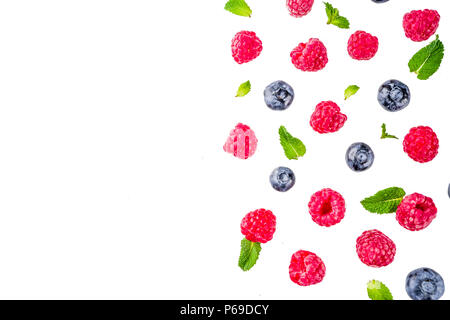 Creative layout with raspberry and blueberry with waffle ice cream cones, simple pattern above copy space Stock Photo