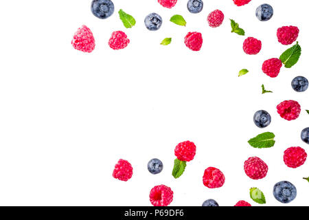 Creative layout with raspberry and blueberry with waffle ice cream cones, simple pattern above copy space Stock Photo