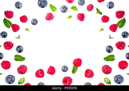 Creative layout with raspberry and blueberry with waffle ice cream cones, simple pattern above copy space Stock Photo
