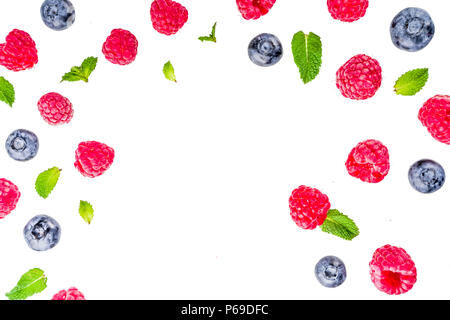 Creative layout with raspberry and blueberry with waffle ice cream cones, simple pattern above copy space Stock Photo