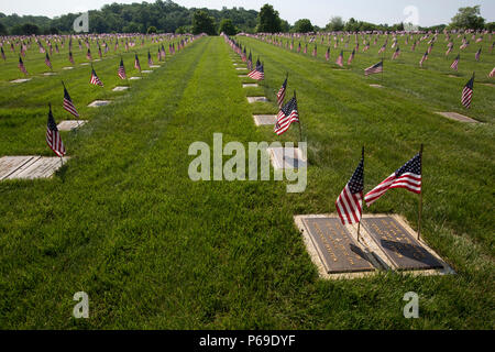 American flags placed by Boy Scouts and Girl Scouts mark the headstones at the Brigadier General William C. Doyle Memorial Cemetery, Wrightstown, N.J., May 28, 2016. Veterans, veterans’ service organizations along with New Jersey National Guard Soldiers and Airmen honor the fallen during the annual State Memorial Day ceremony at the Cemetery. The ceremony culminated with the presentation of memorial wreaths by representatives of veteran service organizations. The Cemetery, dedicated in 1986, is New Jersey’s sole state-operated veterans’ cemetery and is managed by the New Jersey Department of M Stock Photo