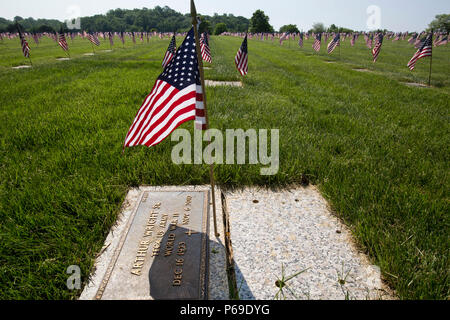 American flags placed by Boy Scouts and Girl Scouts mark the headstones at the Brigadier General William C. Doyle Memorial Cemetery, Wrightstown, N.J., May 28, 2016. Veterans, veterans’ service organizations along with New Jersey National Guard Soldiers and Airmen honor the fallen during the annual State Memorial Day ceremony at the Cemetery. The ceremony culminated with the presentation of memorial wreaths by representatives of veteran service organizations. The Cemetery, dedicated in 1986, is New Jersey’s sole state-operated veterans’ cemetery and is managed by the New Jersey Department of M Stock Photo