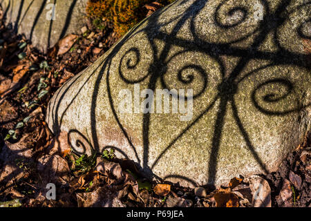 Heart shadows made by wrought iron fence. Stock Photo