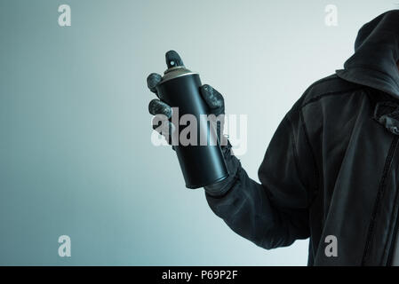 Youth holding spray paint can Stock Photo - Alamy