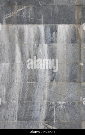 Background texture of a wall from an old gray granite tiles . Stock Photo