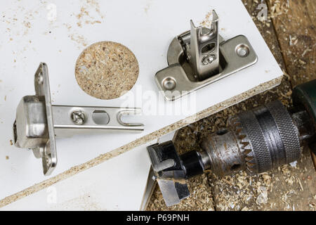 Milling cutter for fixing hinges in chipboard. Joinery accessories for furniture construction. Place - an old carpentry workshop. Stock Photo